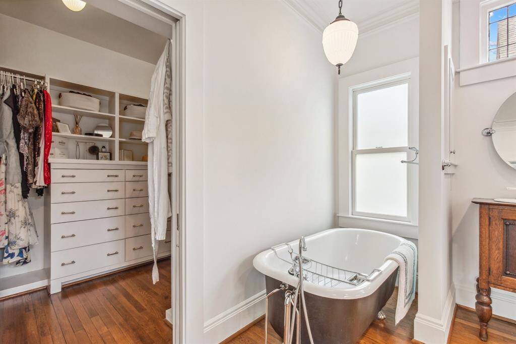 In the bedroom suite, double pocket doors open the bedroom to an exquisite en suite bathroom and a custom walk-in closet.