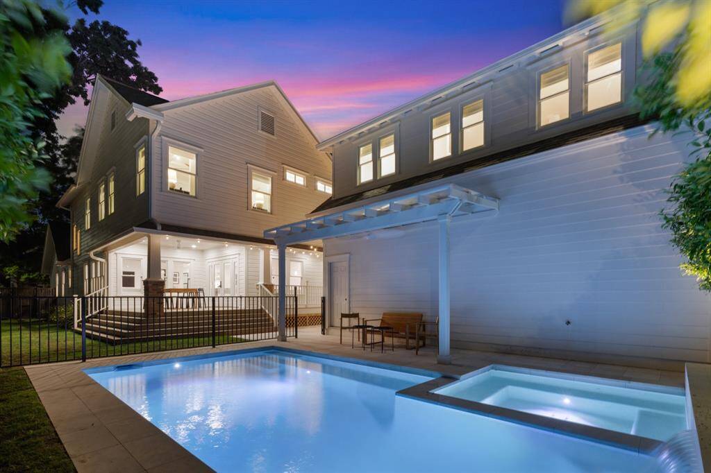 Atop the garage, the sun-kissed apartment/studio space provides an ideal destination for staff, guests and home office use with smart-controlled HVAC, a ceiling fan, engineered hardwood floors and large windows framing treetop views.