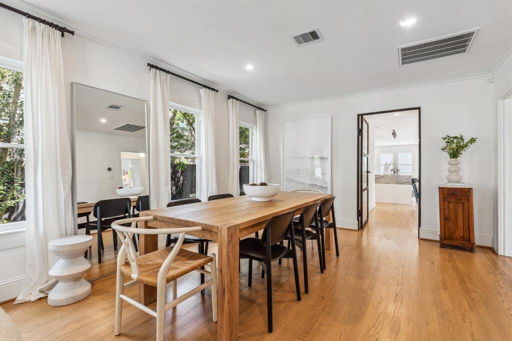 Exceptionally designed custom steel doors with fluted glass create separation between the formal living and dining spaces and the kitchen and family room ahead. This space can also be closed off from the rest of the house.