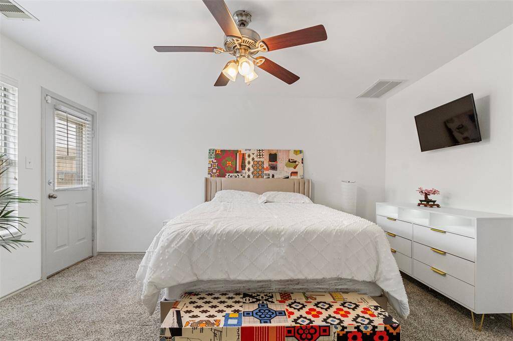 Bright and inviting guest bedroom with ample closet space and large windows. This room is perfect for visitors or could serve as a home office or study.