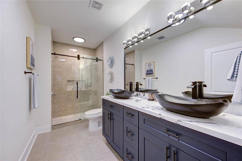 Primary bath with double sinks and large shower.