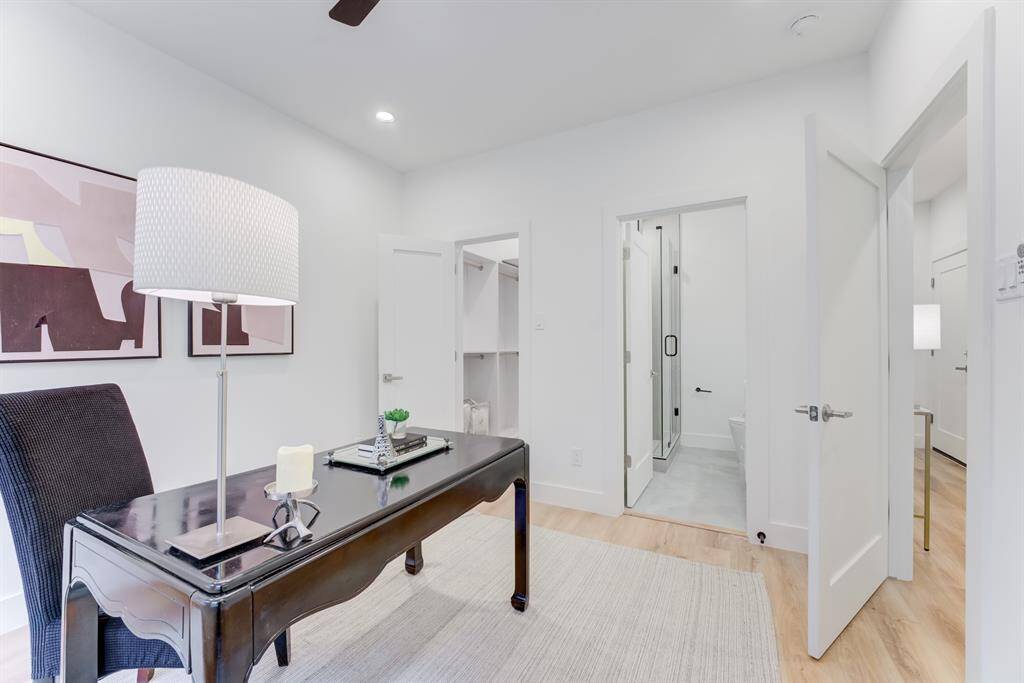 First floor bedroom with en-suite bathroom, ceiling fan, recessed  lighting, and luxury vinyl plank flooring. The 2 large double paned  windows bring in an abundance of natural light.