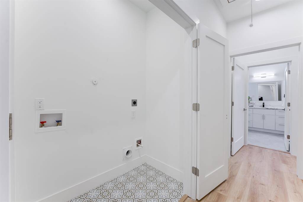 Elegant double door utility room  with stylish tile flooring.