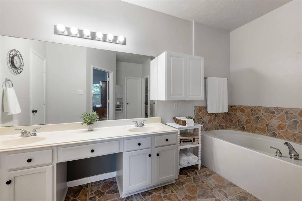 The primary en-suite is warm and inviting with a large walk in closet