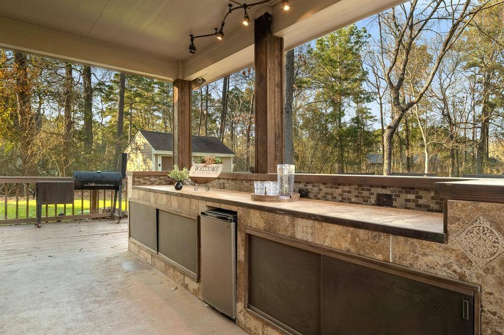 Custom outside bar that includes plenty of storage and an outdoor refrigerator
