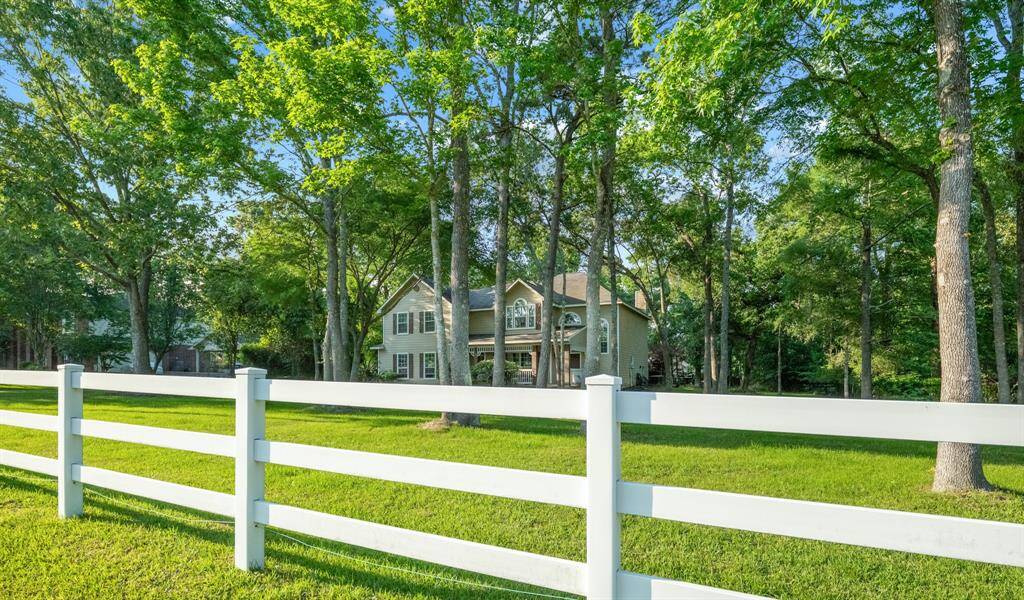 White ranch fencing border all the roads in the neighborhood