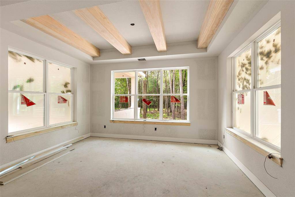 Surrounded by windows, the dining room enjoys views of the trees.