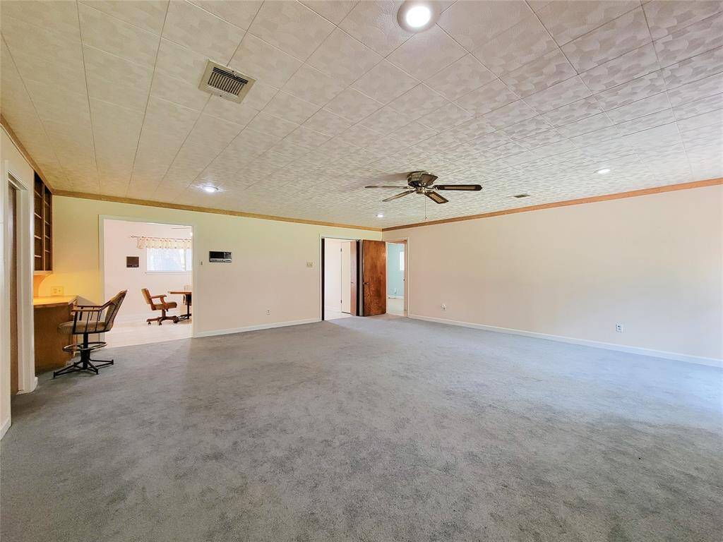 Alternate view of the huge family room highlights a fantastic work space and access to the kitchen.