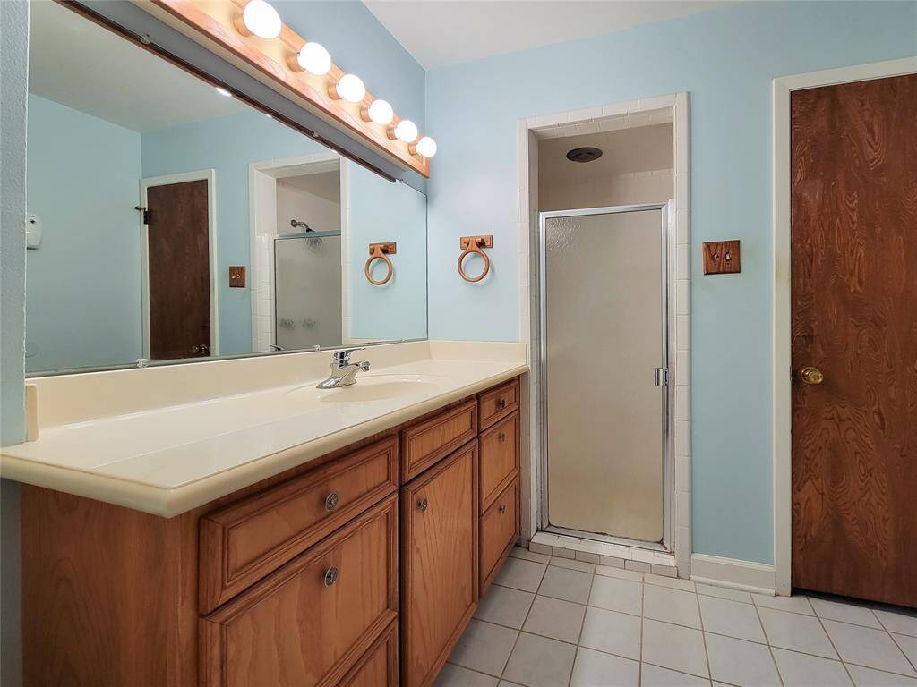 Primary bath with large vanity and shower.
