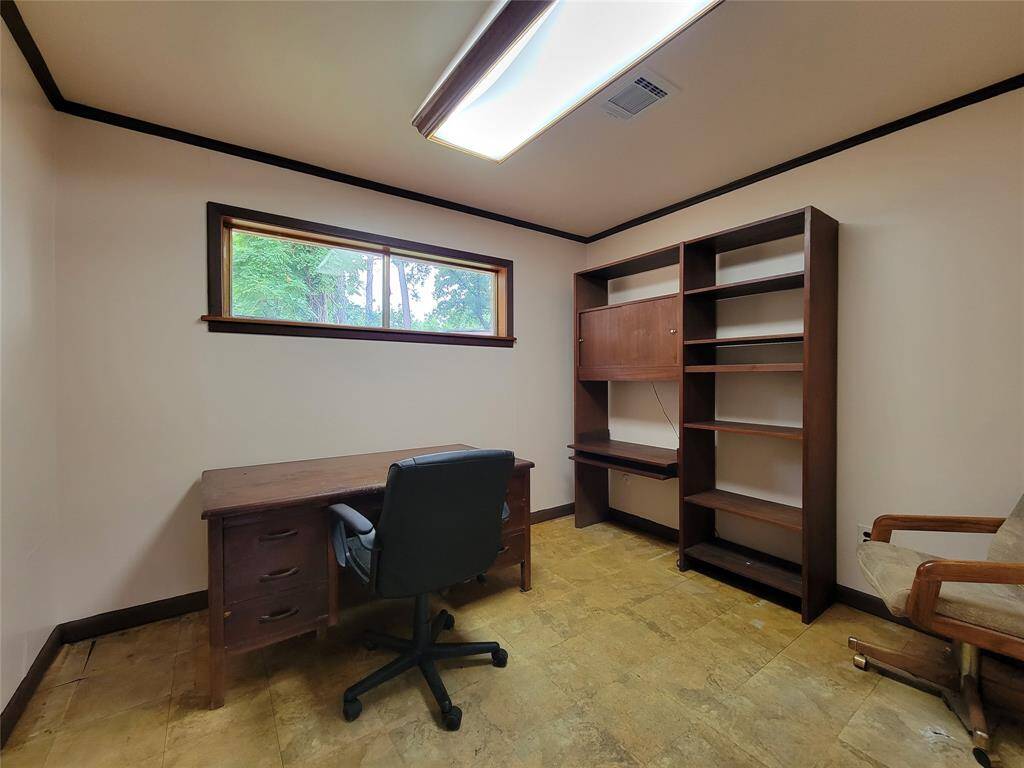 This office offers a separate work space off of the garage.