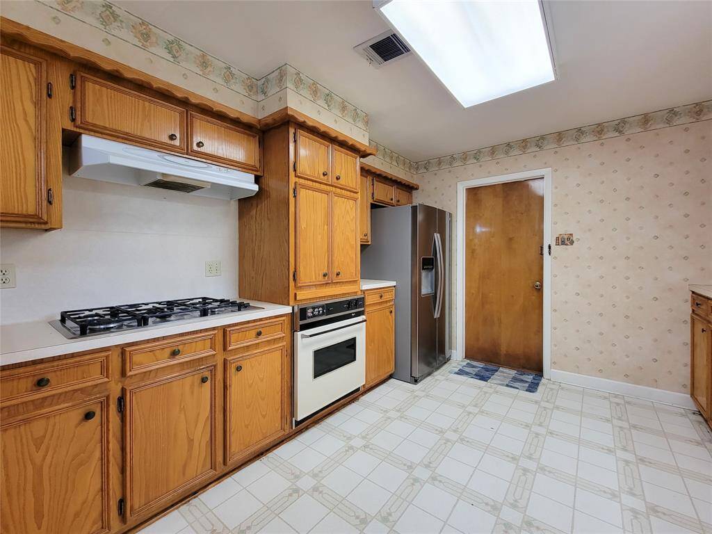 The kitchen features a five burner high end stainless steel range any home cook would love to have.