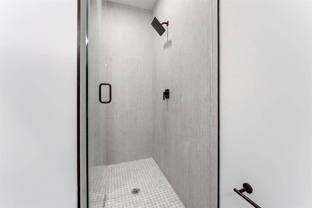 Gorgeous black accented shower with neutral toned tiling.