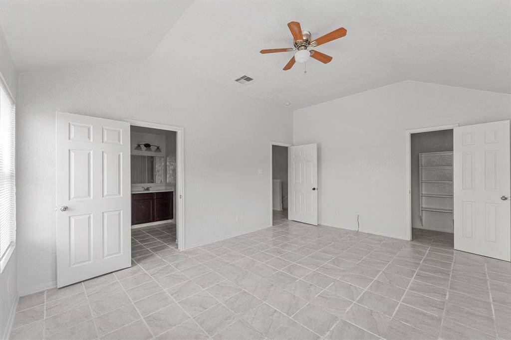This master bedroom is complete with a walk-in closet and an en-suite bathroom.