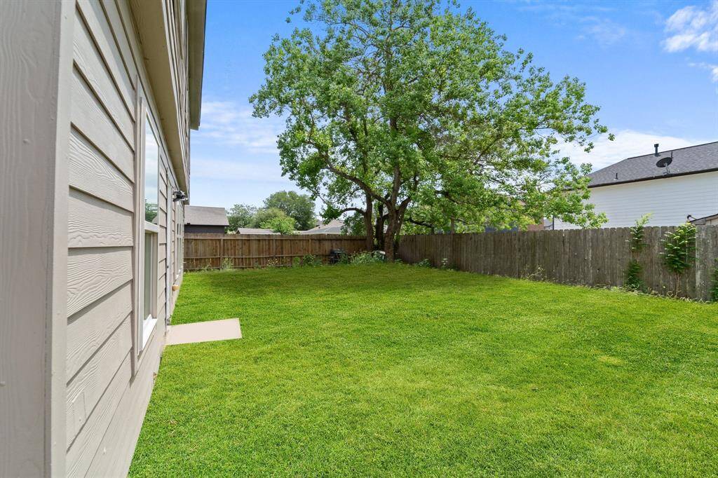 This backyard features solid board fencing providing more privacy.