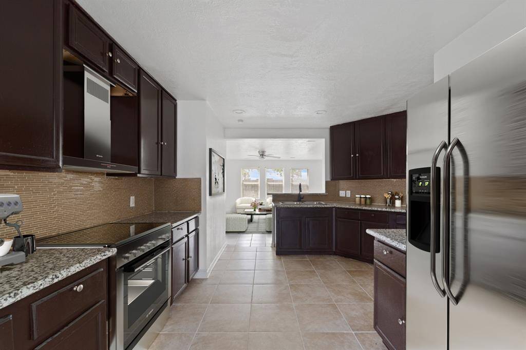 Virtually Staged: This kitchen is grand, has plenty of storage space, and granite countertops. It has immediate access to the living room.