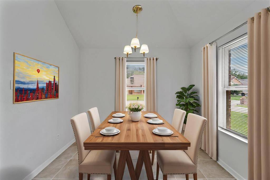Virtually Staged: Spacious dining room with tile floors, pendant lighting, crown molding, and large windows.