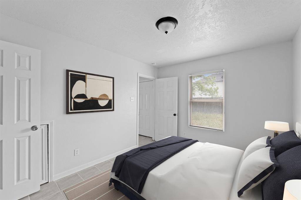 Virtually Staged: This secondary bedroom is located downstairs and has great views into the backyard.