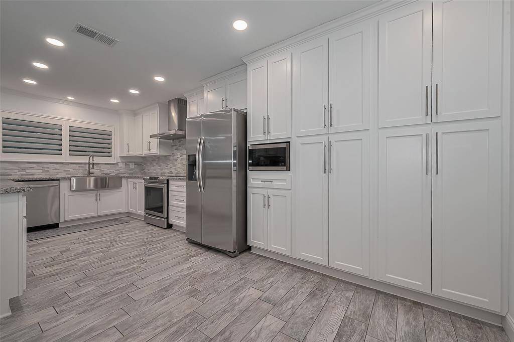 Fully remodeled kitchen - stainless steel refrigerator stays