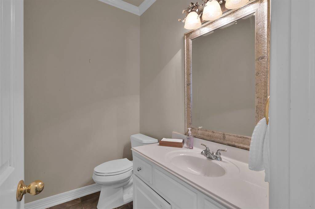 Tucked off the living room you will find a larger than usual half bath with extended counter and cabinet area and decorative mirror. Just outside this bathroom is the Nest digital thermostat controllable remotely via a phone app or a website making it easy to make changes while you are away from home. This home also has a Interlock installed for a portable generator allowing you to back feed your panel and power circuits in the home using a portable generator.