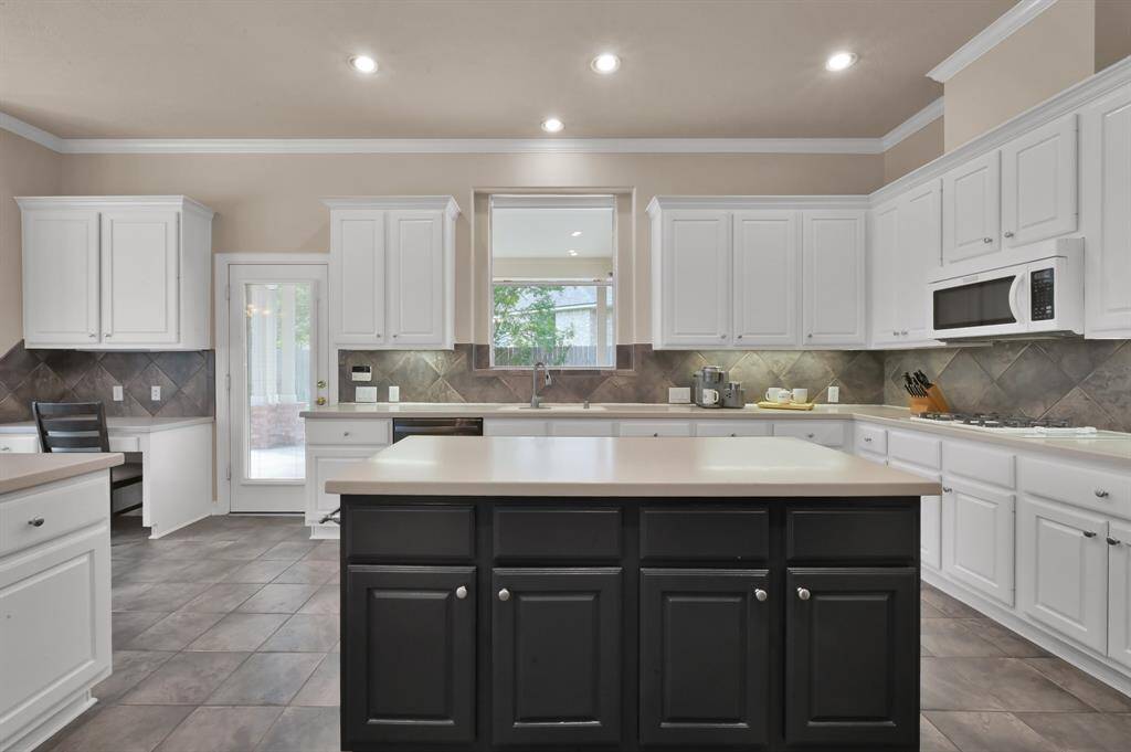 Prepping meals is a breeze on this solid surface island, providing a large area with dual-side cabinets and an electrical plug on both ends. Extensive counters around the perimeter give you even more room for various tasks. Those with cabinets above also have under cabinet lighting. Clean up is easy with a dual-basin sink, pull-down satin nickel finish faucet and stainless-steel dishwasher which was replaced in 2021.