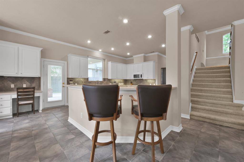 This entertaining kitchen also has a long bar area with room for multiple bar stools.