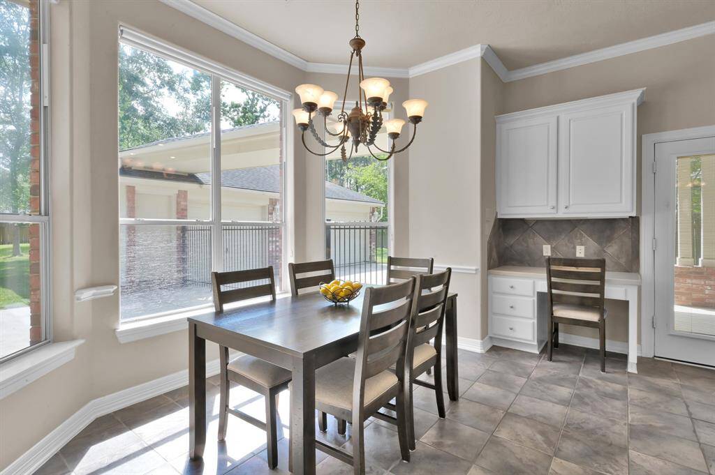 The breakfast room has space for a large table to enjoy meals while looking out four tall windows overlooking the back yard. If you prefer additional privacy, easy to operate Hunter Douglas shades provide this.A built-in desk with upper cabinets and drawers help with keeping the kitchen tidy and supplies close by to the heart of the home.