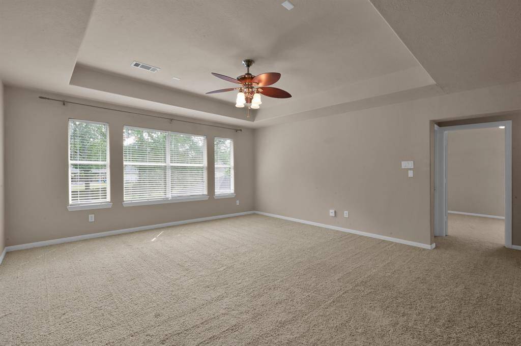 The game room has an ~9' tray ceiling, 2" faux wood blinds, ceiling fan with light in addition to the can lights and is wired for sound. The windows overlook the back yard and pool area. As you walk across the room through the opening you will enter a hallway with two additional bedrooms, bathroom and a walk-in Texas basement.