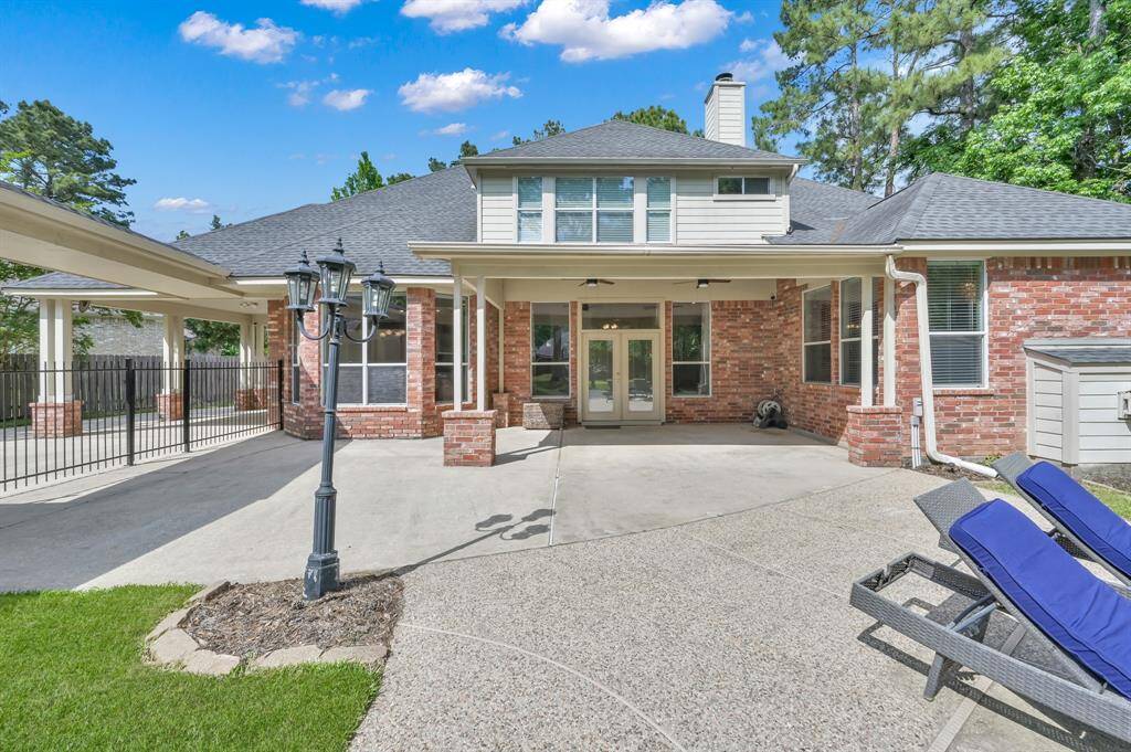 This view shows you how much area there is for outdoor furniture options. The three-light outdoor post lamp gives you another light source as well. This home also has gutters installed on most areas of the exterior.