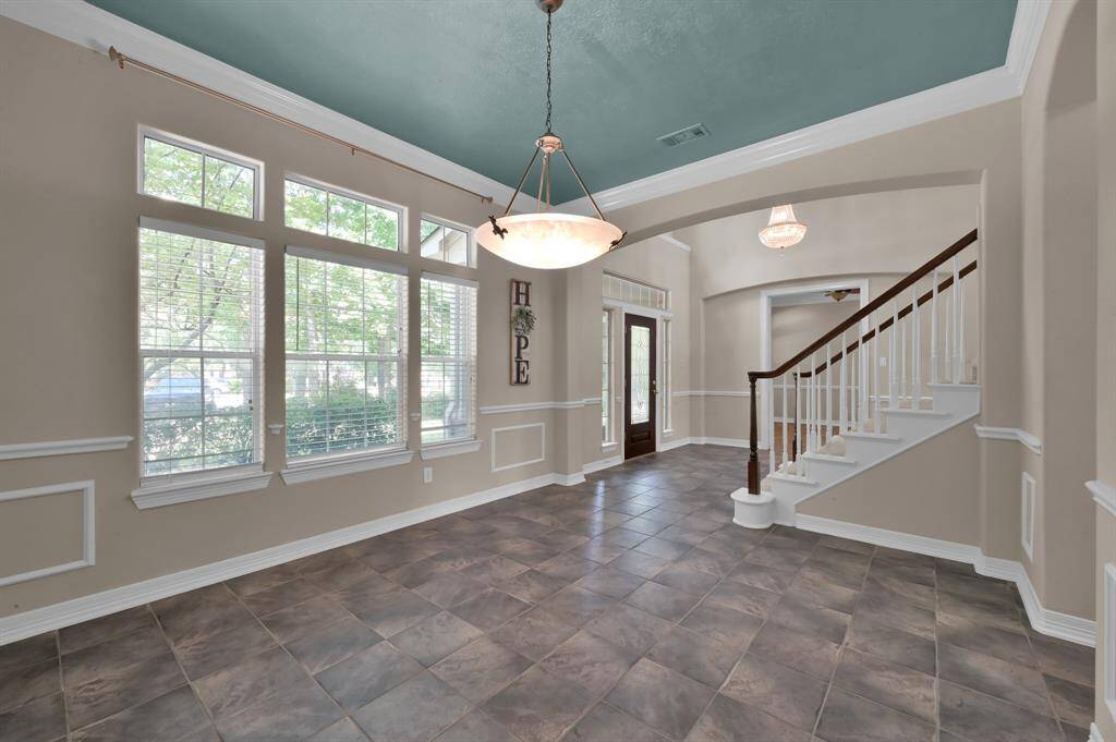 The dining room/flex space is also located at the front of the home. Enjoy entertaining guests in this large room for a special meal or possibly use it for a downstairs playroom or second office. It features crown molding, chair rail and a painted ceiling.