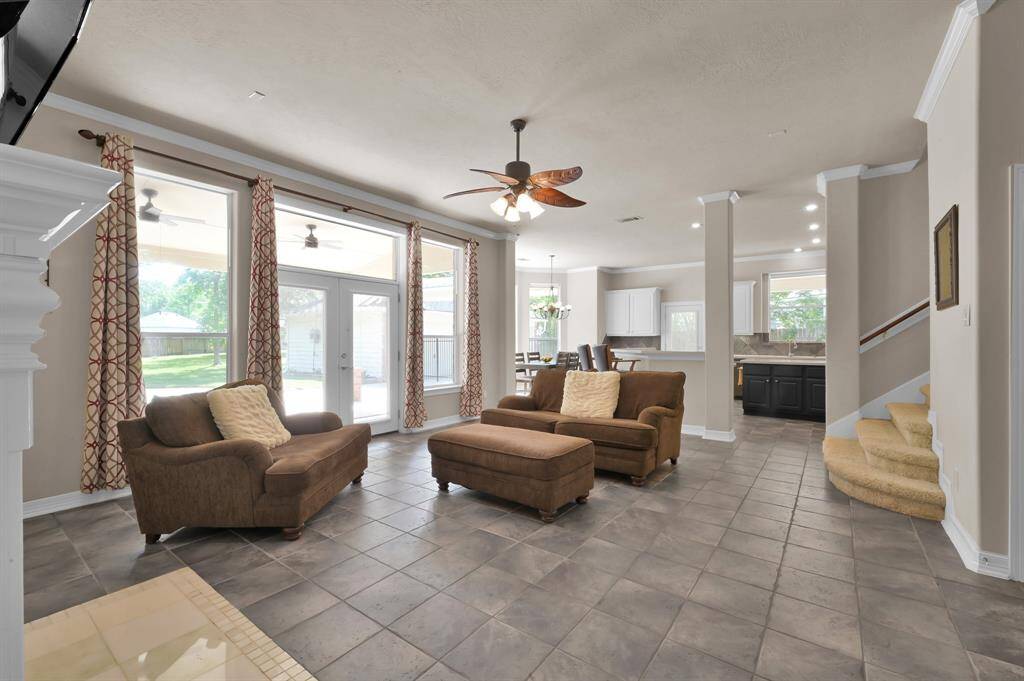 From the living room enjoy beautiful views of your back yard through the glass French doors flanked by two additional windows. These all let in an abundance of natural light.