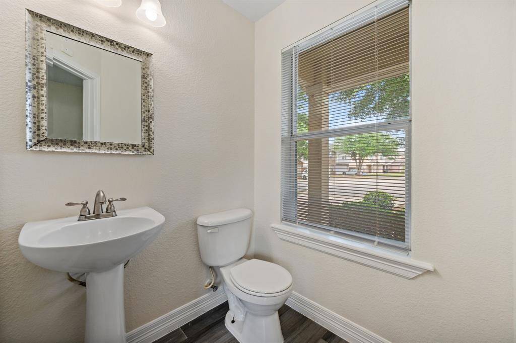 Main floor powder room with updated fixtures and natural light.