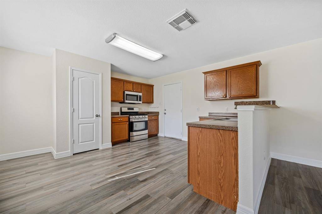 View into kitchen with breakfast bar and 2-car garage access.