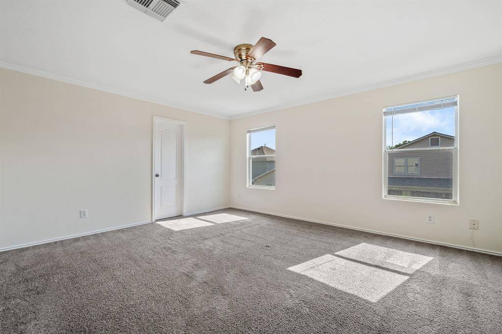 Primary bedroom with fresh carpet and generous space.
