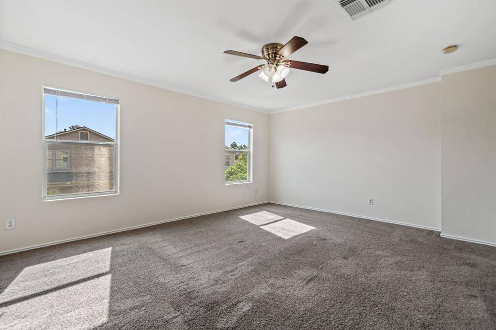 Another angle of the primary bedroom with great natural light.