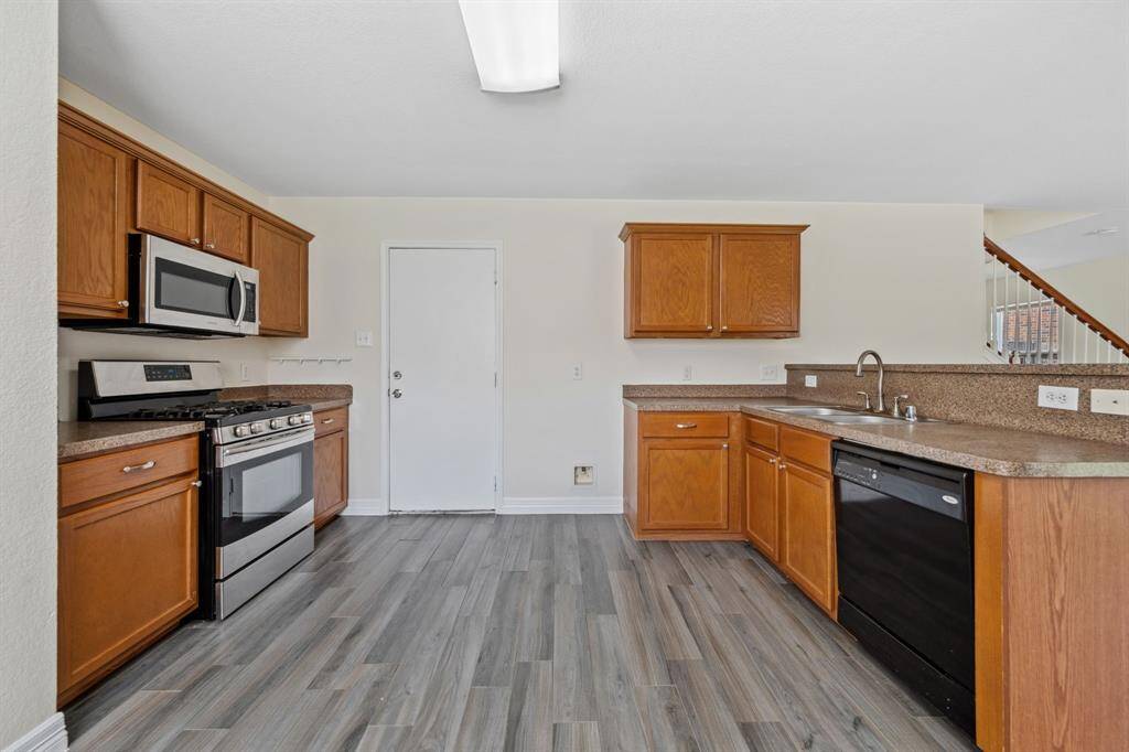 Bright kitchen with tile flooring and plenty of cabinet space.