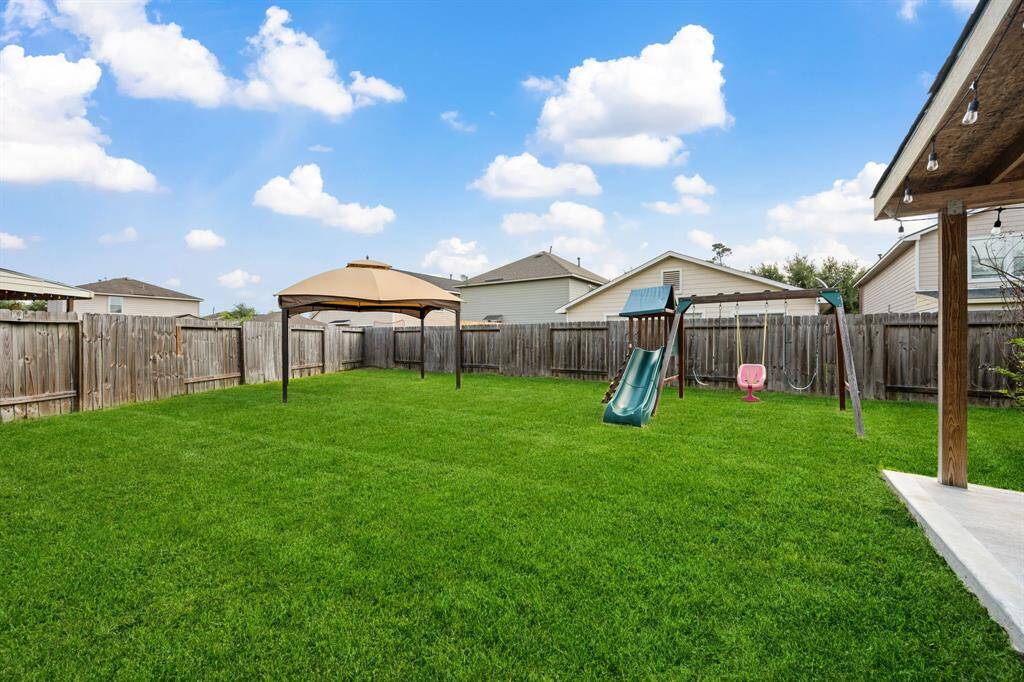 Wide backyard with room for gardening, pets, or play.