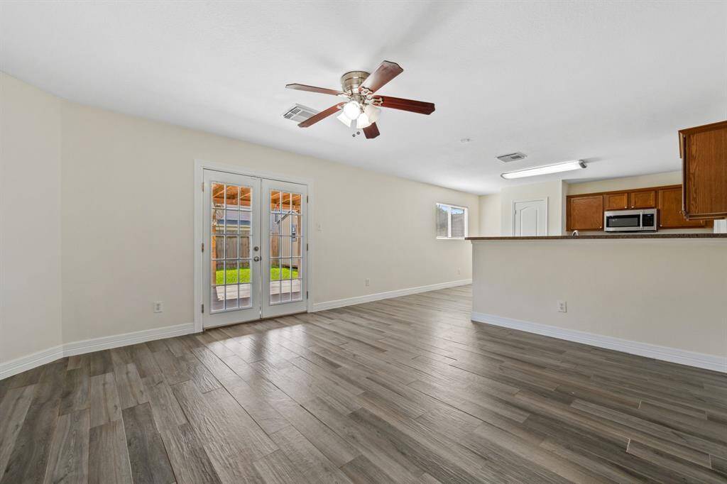 Open-concept layout between kitchen, dining, and living area.