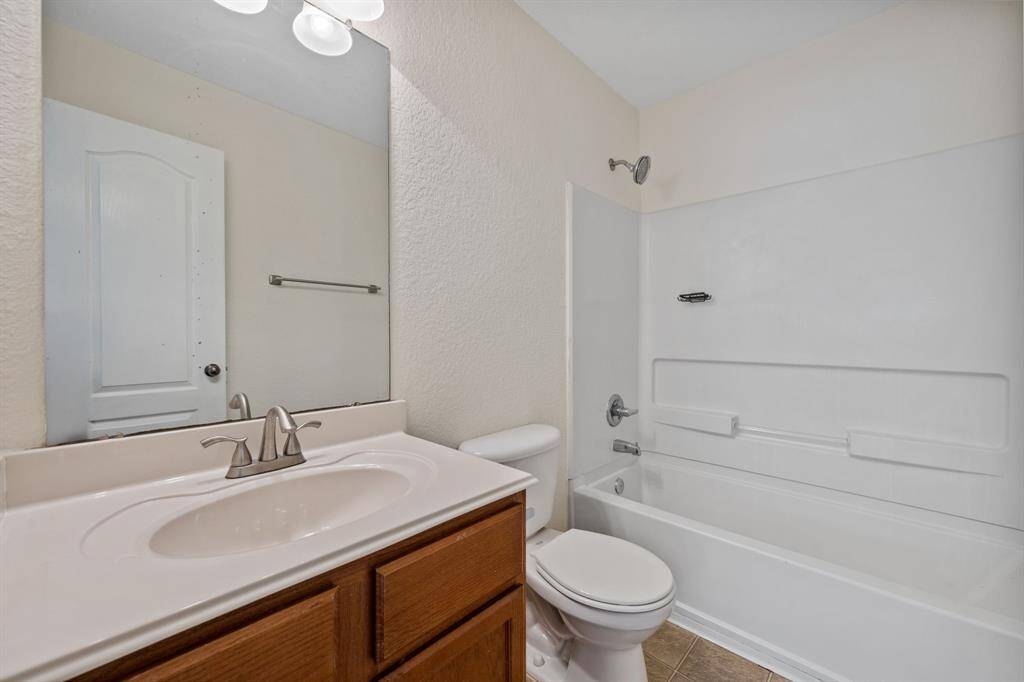 Upstairs full bath with tub/shower combo and large vanity.