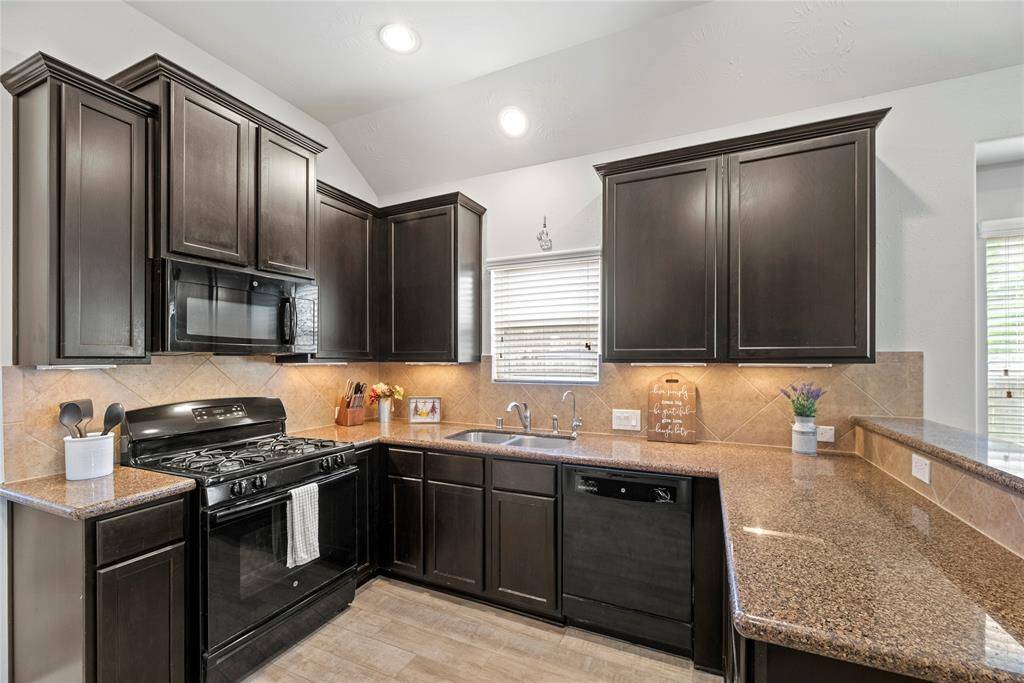 The space is well-lit with natural light from a window above the sink, adding warmth and functionality.