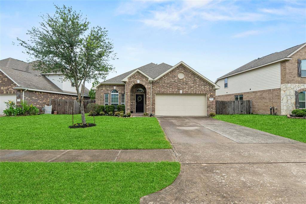Wide driveway with a two car garage.