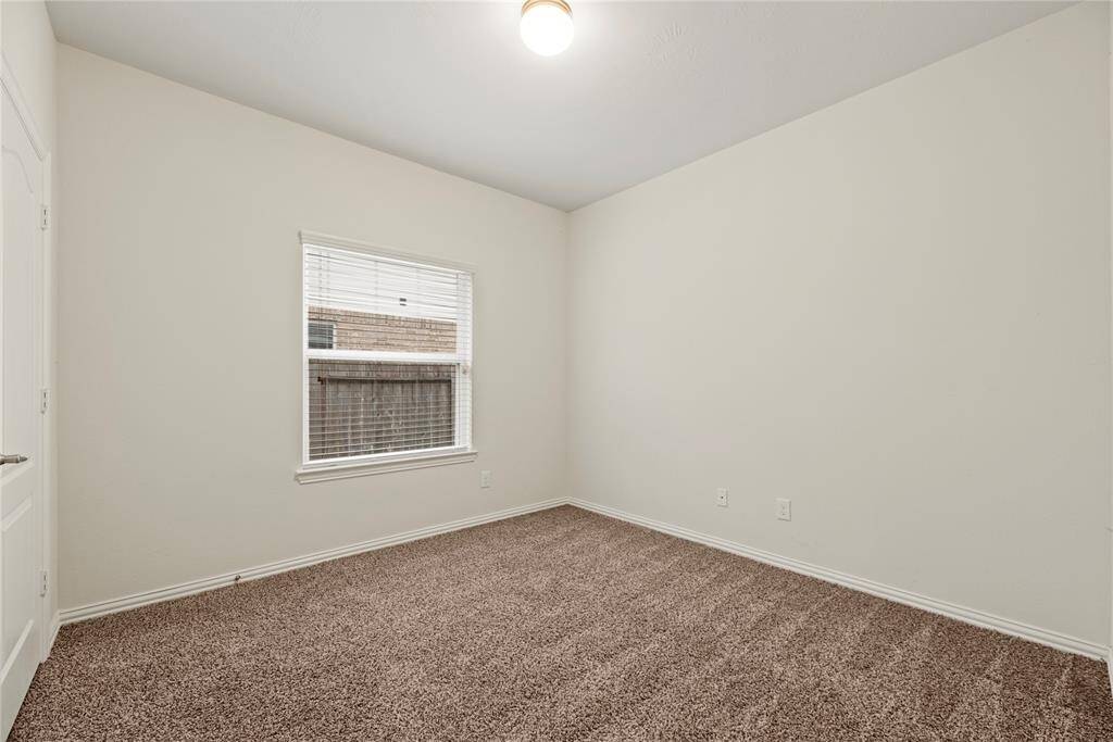 Bedroom # 3 - is a cozy also with neutral walls, carpeted floor, and a single window providing natural light.