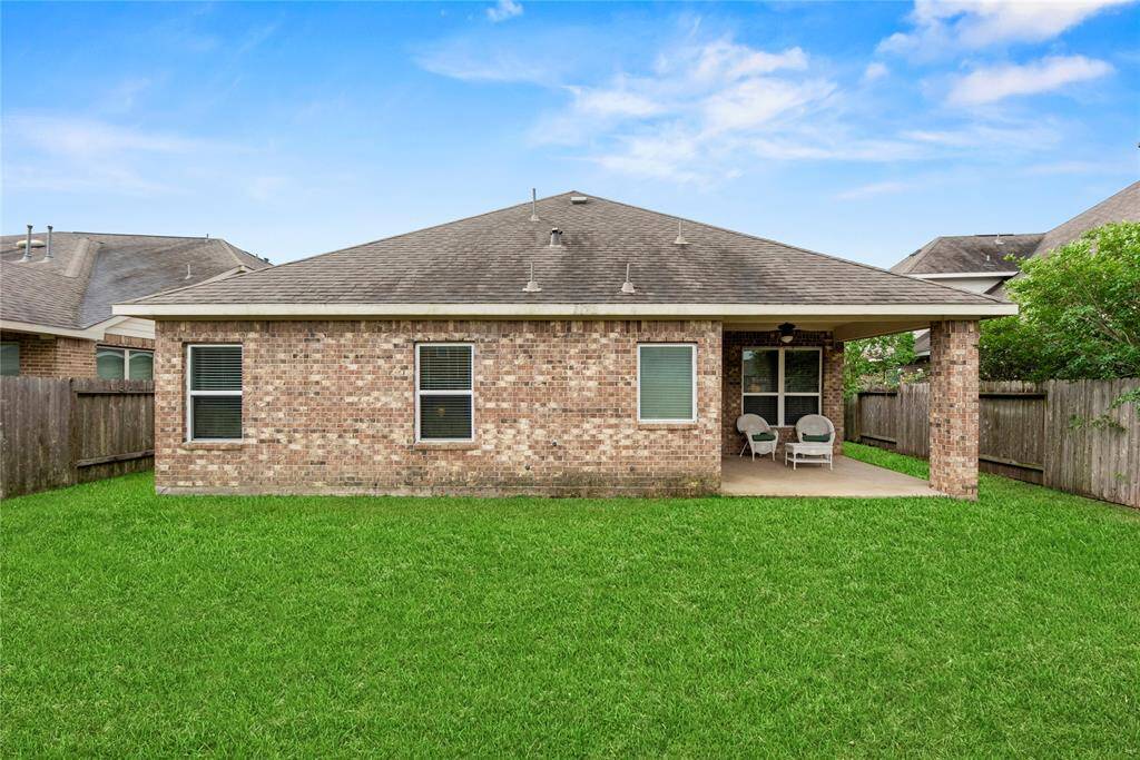 Another angle of the spacious backyard and covered patio area.