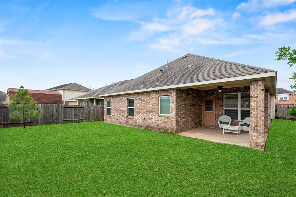 Another angle of the spacious backyard and covered patio area.