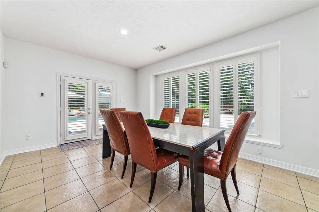 The large, sunny breakfast room flows seamlessly into the living area, tailored for easy entertaining. From this room you can enjoy views of the backyard and it also offers exterior access that leads to the patio area...the perfect spot for your morning coffee or tea.