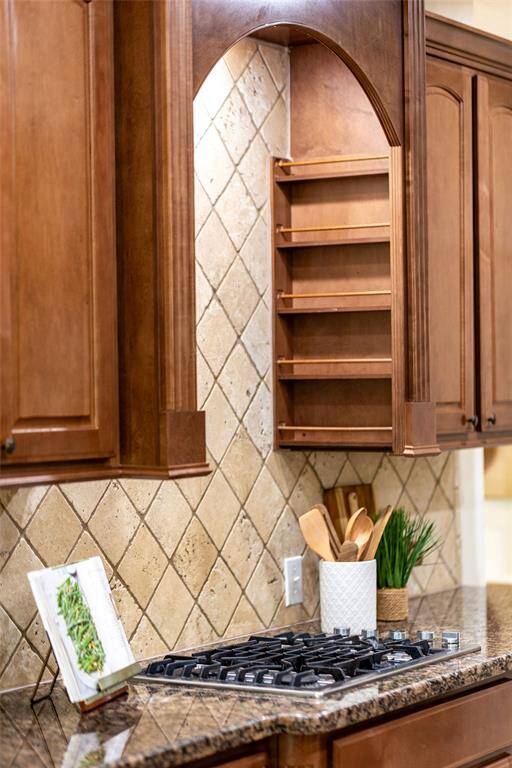 A perennial favorite for any gourmet cook is a gas cooktop...and thoughtful and convenient spice racks flank the cooktop.