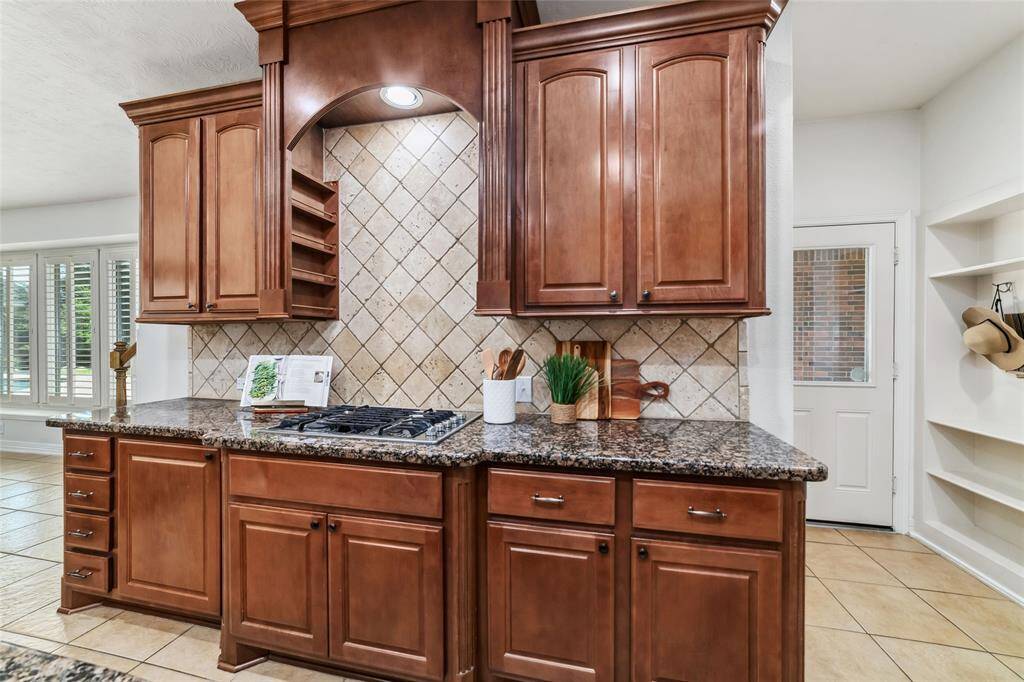 Another view of the gas cooktop area. To the right of this area is the large walk-in pantry and the mud area/drop zone before leading into the laundry room.