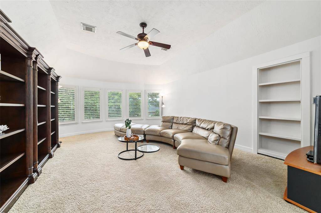 Upstairs you're greeted with an oversized game room, with windows overlooking the expansive backyard. There's also a hidden bookcase that houses a good-sized room that can be used for extra storage and/or to accommodate security equipment.