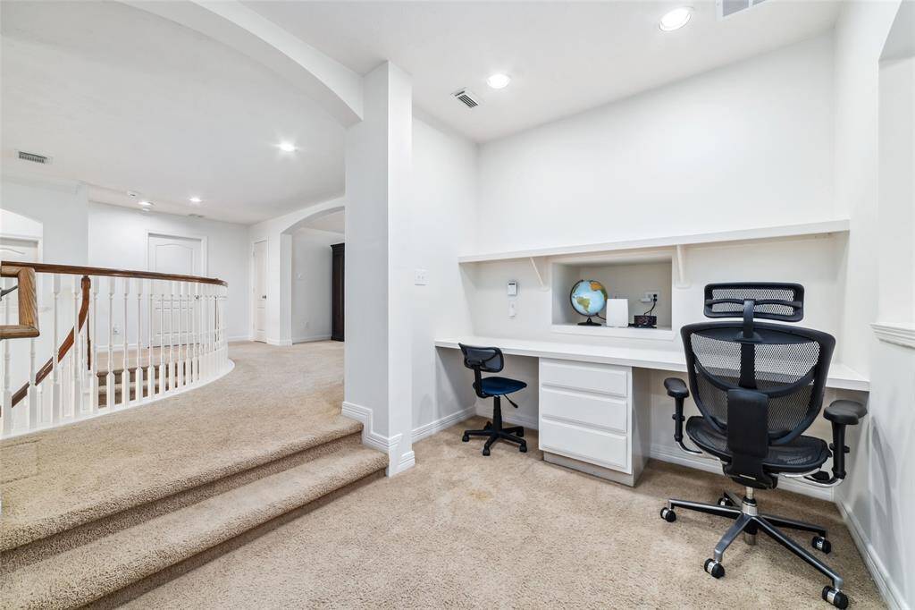 A very functional study nook - located between the left upstairs area (game room and the first 2 bedrooms and bathrooms) and the upper right side of the home. Directly to the right of this area is the home's second staircase.
