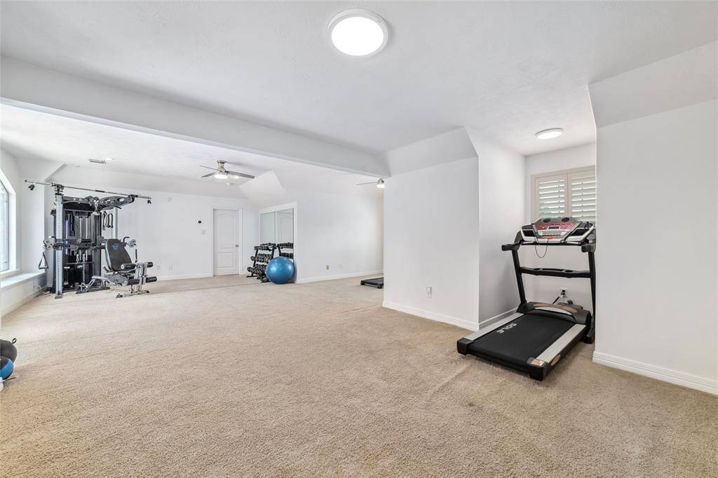 Huge flex space (31x15)! This space is currently being utilized as a comprehensive (& enviable!) home gym. This room could be used many ways - with a fun pool table, large TV room, second office, craft space, etc…the possibilities are endless. And you can't beat the gorgeous view, overlooking the resort-style backyard!