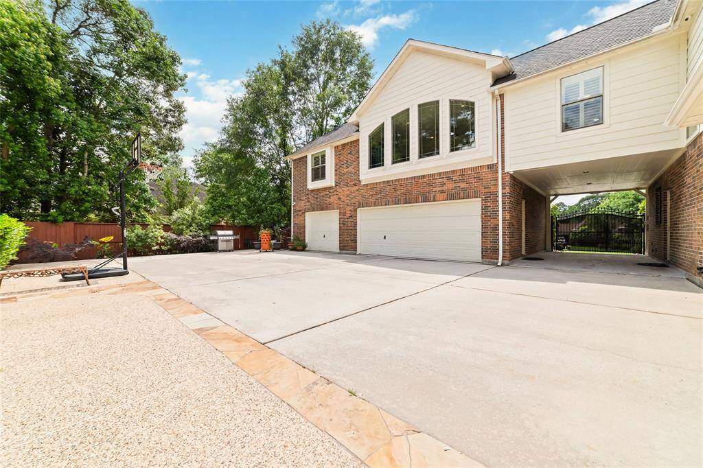 This is a view of the 3 car garage, motor court and porte-cochere area. This affords lots of space to play or abundant room for overflow parking.